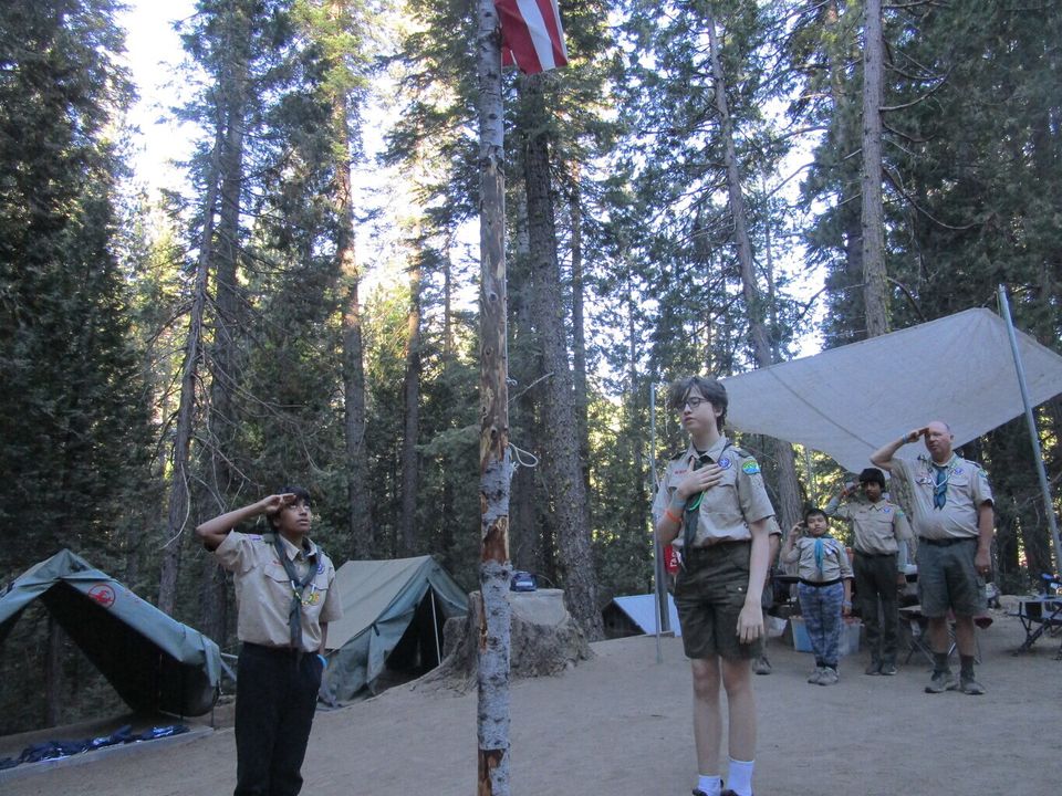 The troop's campsite among the tall pines
